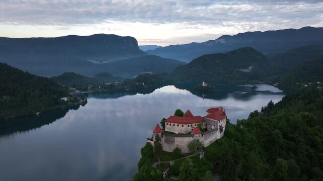 Bled, Slovenia - Aerial drone view of beautiful Bled Castle Blejski Grad with Lake Bled Blejsko Jezero, the Church of the Assumption of Maria and Julian Alps