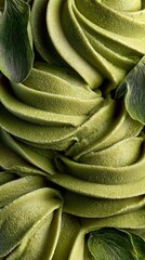 Close-Up of Matcha Green Tea Ice Cream Texture.Macro photography of swirled matcha green tea ice cream or soft serve with creamy texture, smooth spirals, and natural green leaf decoration.
