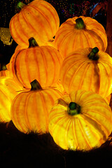 Christmas-themed pumpkin lanterns are placed on the lawn as part of the outdoor decorative lighting