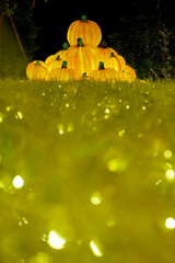 Christmas-themed pumpkin lanterns are placed on the lawn as part of the outdoor decorative lighting