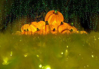 Christmas-themed pumpkin lanterns are placed on the lawn as part of the outdoor decorative lighting