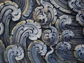 Intricate Stone Carving of Swirling Waves and Ocean Motifs