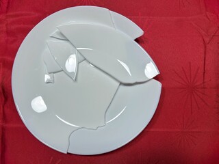 Broken ceramic plate on table symbolizing accident or damage