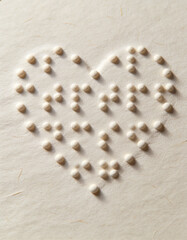 Braille dots forming a heart on textured paper, soft shadows, minimalistic style, symbolizing compassion, inclusion, accessibility, and awareness for World Braille Day and literacy