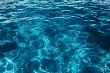 Obraz premium Calm Ocean Water Surface with Sunlight Reflections Creating Gentle Ripples for a Relaxing Atmosphere