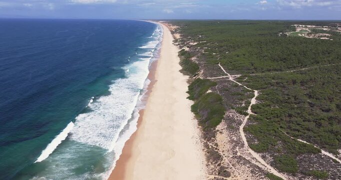 Waves breaking on beach on the Alentejo Coast, Portugal, Europe. Still aerial drone shot. Calming nature, natural, organic textures. Cinematic grading