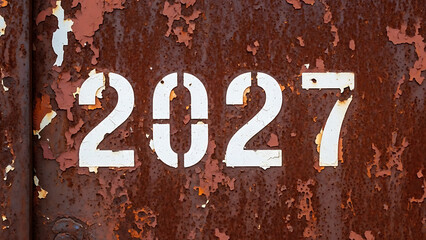 Futuristic 2027 text effect design on a modern digital background with glowing typography, dynamic light trails, and abstract motion. Perfect for future technology, innovation, and next-year concept.