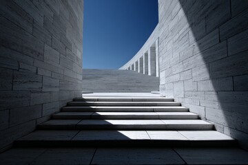 Modern architectural stone staircase with sunlit shadows and blue sky