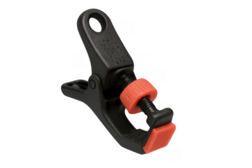 Black and orange plastic spring clamp tool on transparent