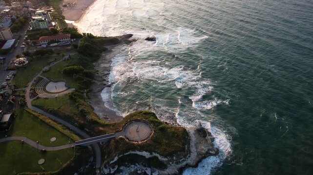 Aerial view of the rugged coastline where the turquoise sea crashes against the rocky shore near the beach, creating a mesmerizing contrast, Lozenets, Tsarevo, Bulgaria.