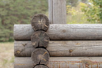 Fragment of a gazebo made of pine logs.