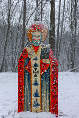 Wooden Saint Icon in Snowy Forest