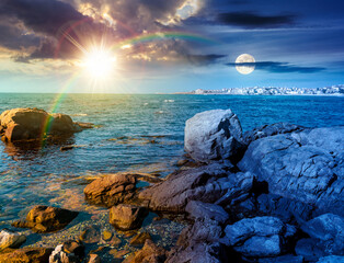 rocky shore of the sea coast under blue sky. day and night time change concept. beautiful view under sun and moon. resort scenery during vacation season in summer. harmony and progress calendar