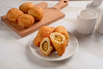 Indonesian fried bread, also known as "Roti Kue Bantal" (pillow bread), is often filled with banana, chocolate, or mung beans. Perfect for recipes, articles or any cooking content.
