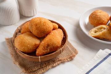 Indonesian fried bread, also known as "Roti Kue Bantal" (pillow bread), is often filled with banana, chocolate, or mung beans. Perfect for recipes, articles or any cooking content.