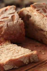 Artisan bread with decorative cuts and a porous crumb on a wooden surface &mdash; ideal for bakery branding