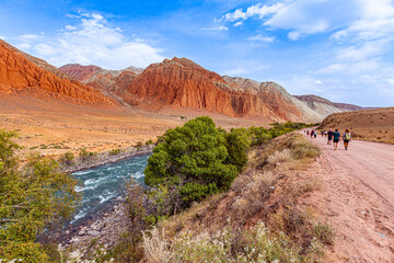Fototapeta premium Mountain landscape with red colored rocks and a canyon of extraordinary beauty in Kyrgyzstan.
