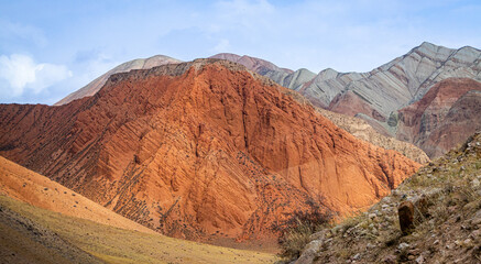 Mountain landscape with red colored rocks and a canyon of extraordinary beauty in Kyrgyzstan.