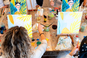 Women enjoying sip and paint art workshop
