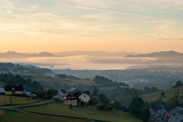 Golden Sunrise over Czorsztyn Lake with Misty Mountain Layers and Countryside