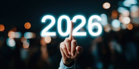 Hand raises middle finger beside bright neon 2026 letters in dark bokeh.