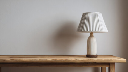 Elegant Table Lamp on Wooden Table Against Neutral Wall.