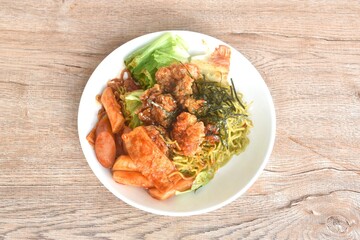 Korean vegetable noodles topping tokpokki slice pork sausage and cabbage with tofu dressing spicy sauce couple fried chicken topping dry seaweed on plate