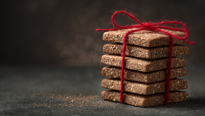 Stack of Sesame Seed Bars Tied with Red String.