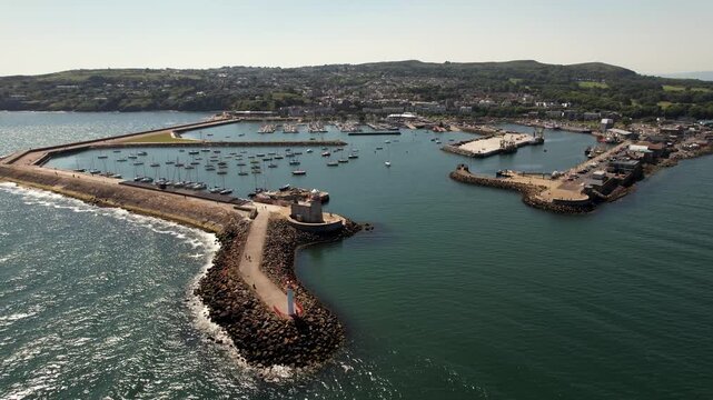 Aerial view of the Howth harbour , where the turquoise waters meet the rugged coastline, Ireland's Eye Island, County Dublin, Ireland.