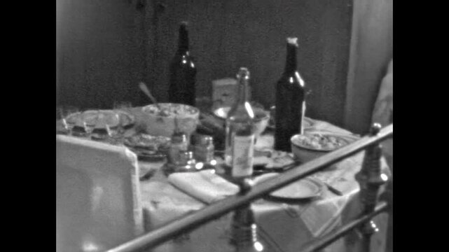 Archival film, abstract festive table with plates, salads, drinks, bottles. No people. Soviet nostalgic domestic scene of celebration and shared moments. Archival retro 1960s. Old vintage archive.