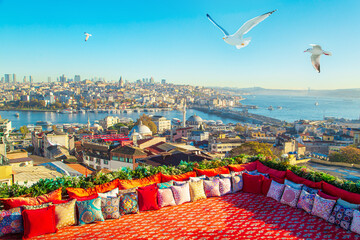 Magnificent panoramic view of Istanbul from the rooftop with traditional Turkish carpet and pillows.