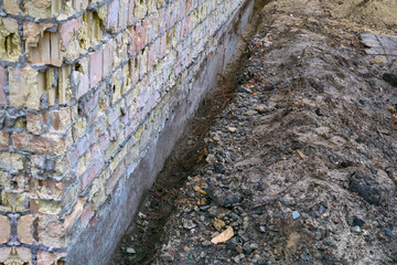 Preparing the building foundation for reinforcement by pouring concrete