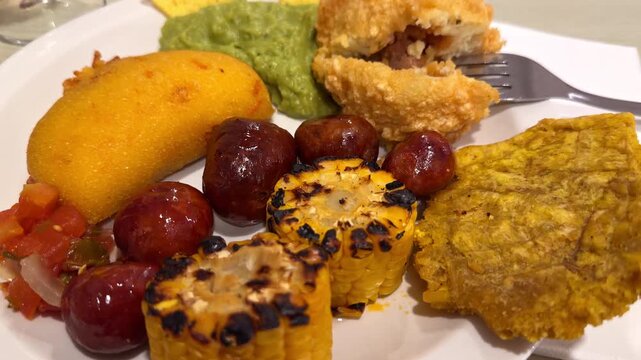 Latin American Food Platter with Chorizo, Guacamole, Arepas, Patacon, Grilled Corn and Salsa