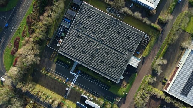 Aerial view of a data center with solar panels contrasts against the surrounding greenery and parking lots, Milton Keynes, England, United Kingdom.