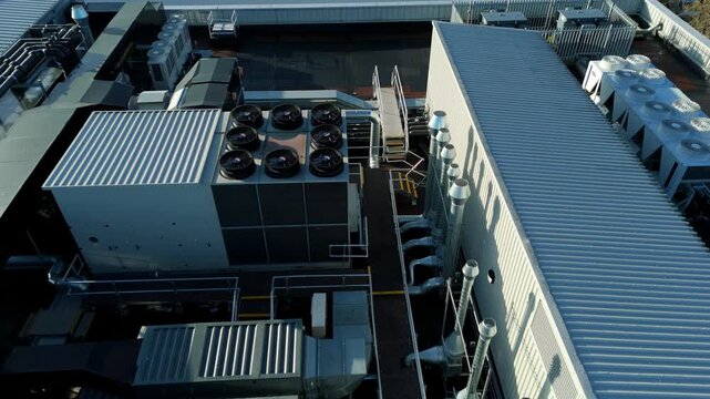 Aerial view of assorted rooftop HVAC systems with silver ducting creating a geometric industrial landscape, Milton Keynes, England, United Kingdom.