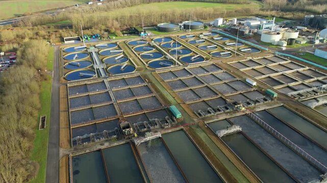 Aerial view of the expansive water treatment plant with a complex network of pools and industrial buildings, Milton Keynes, England, United Kingdom.