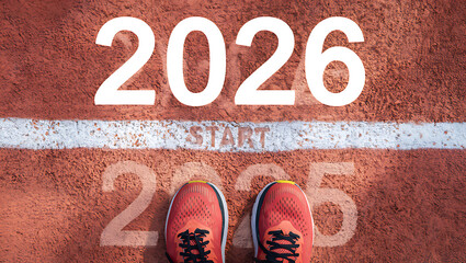 A top-down view of a runner's feet at the "START" line, changing from 2025 to 2026.