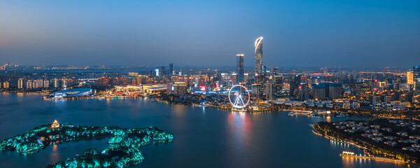 Aerial night view of Peach Blossom Island Ferris Wheel at Jinji Lake, Suzhou, Jiangsu, China