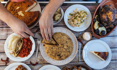 Hands serving a homemade spanish omelet at dinner