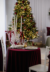 Decorated table with candles and pearls in a decorated room