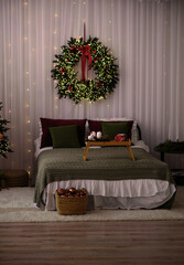 A large bed with a green bedspread is decorated for the New Year.