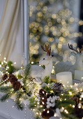 Christmas decoration in the form of a deer with lights and plants