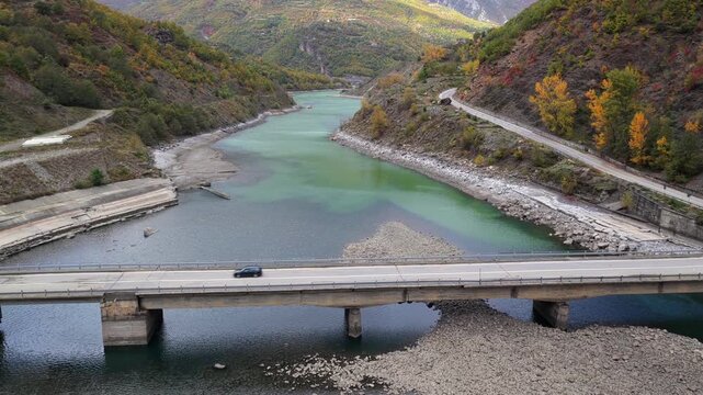 Aerial video of a Car driving over a Bridge of Fierza lake in Northern Albania. 