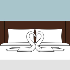 Hotel bed with towels folded as swans