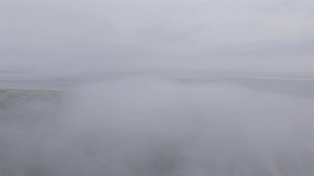 Aerial view of an overcast sky, with muted grey tones blending seamlessly, creating a serene yet melancholic atmosphere over the horizon, Gloucester, Massachusetts, United States.