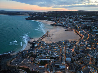 Vibrant twilight elevated capture of St Ives town, bay and beaches in Cornwall, UK