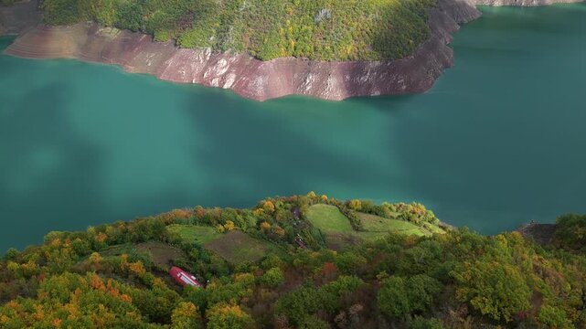 Aerial video of Fierza Lake with autumn hills, turquoise water in Northern Albania. 