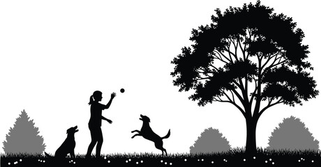 Silhouette of a woman playing fetch with her two dogs in a park with a large tree and bushes, happiness.