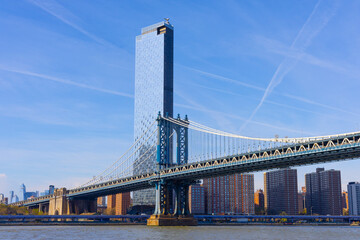 Manhattan Bridge spans the East River, connecting Brooklyn and Manhattan, with the city skyline.
