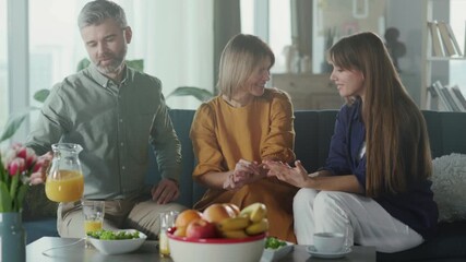 Sunlit kitchen with family sharing meal, An intimate family moment in bright kitchen with supportive interactions